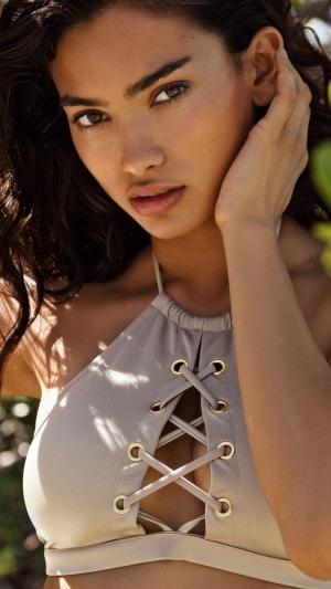 Kelly Gale in a beige bikini top
