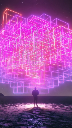 Man standing before a neon cube structure