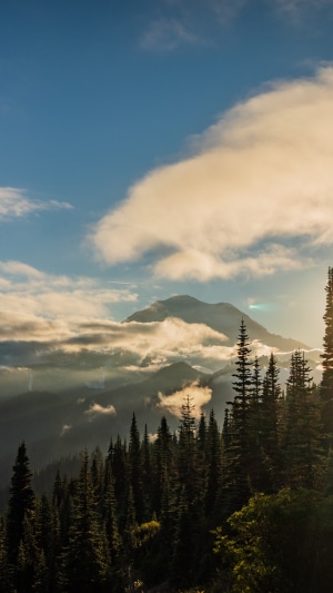 Mountain peak shrouded in clouds at sunset
