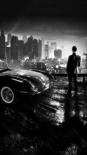 Man in Suit Standing by Vintage Car Overlooking Cityscape