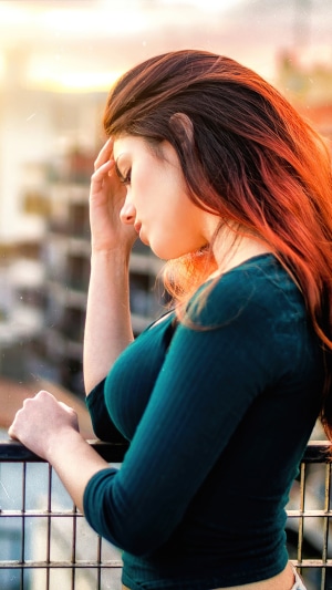 Woman on a balcony at sunset