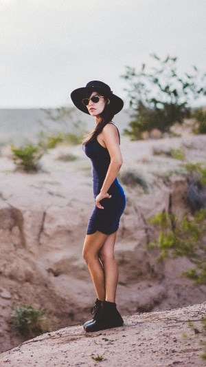 Woman in hat and sunglasses in desert