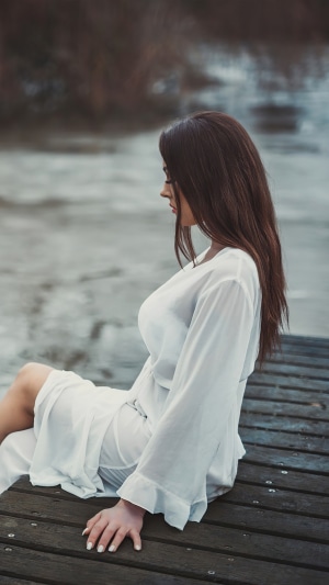 Woman in white dress on a pier