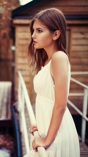 Girl in white dress on a bridge
