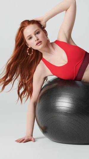 Madelaine Petsch posing with a fitness ball