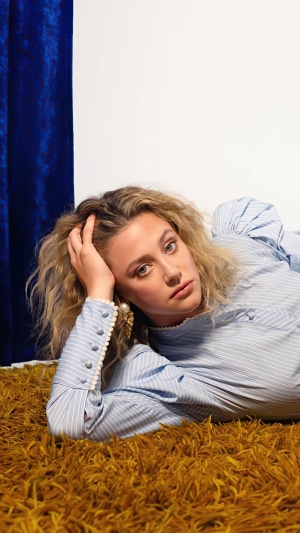 Lili Reinhart posing on a furry rug