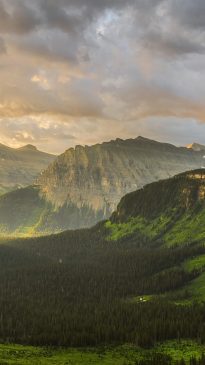Mountain range at sunrise with clouds