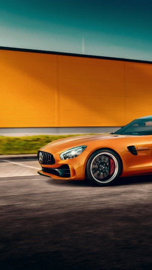 Orange Mercedes-AMG GT driving on asphalt