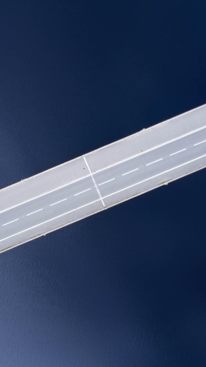 Aerial view of a bridge over dark blue water