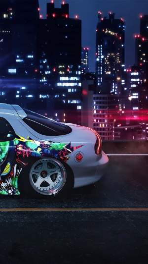 Car with anime artwork in a city at night