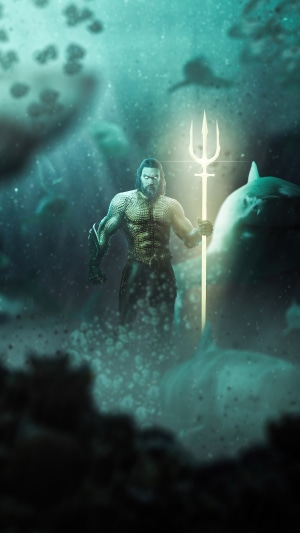 Aquaman holding a trident underwater with sharks