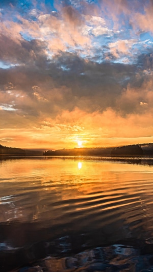 Sunset over a calm lake with colorful clouds