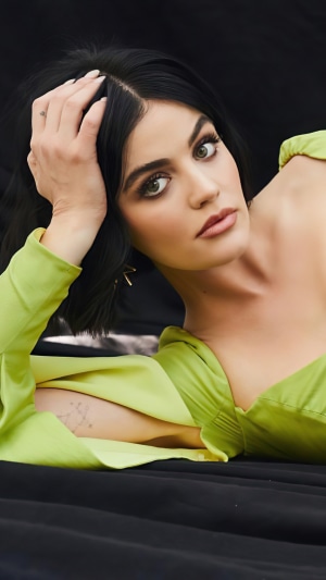 Lucy Hale posing in a green dress