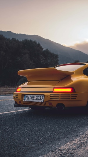Yellow Porsche 911 rear view on road