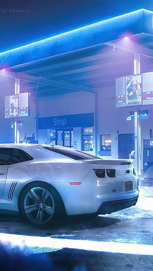 White Chevrolet Camaro at a gas station at night