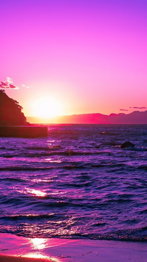 Sunset over the ocean with purple hues 4K