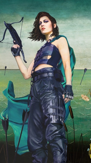 Woman with crossbow in a green landscape
