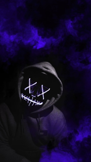 Person in Anonymous mask and hoodie with purple smoke
