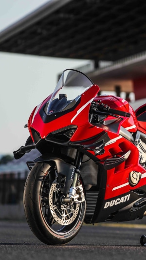 Red Ducati motorcycle parked outdoors