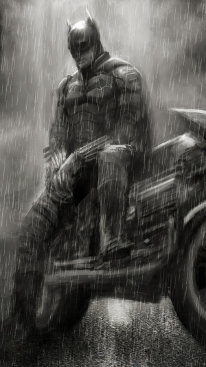 Batman sitting on a motorcycle in the rain