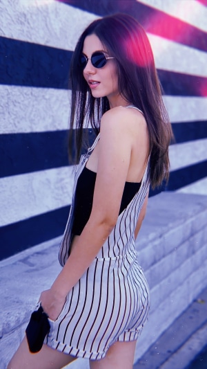Victoria Justice wearing overalls and sunglasses