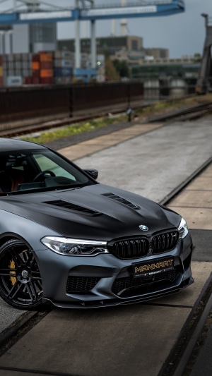 Manhart BMW M5 car on industrial railway tracks