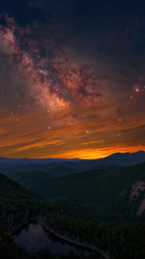 Milky Way over mountains and lake at sunset
