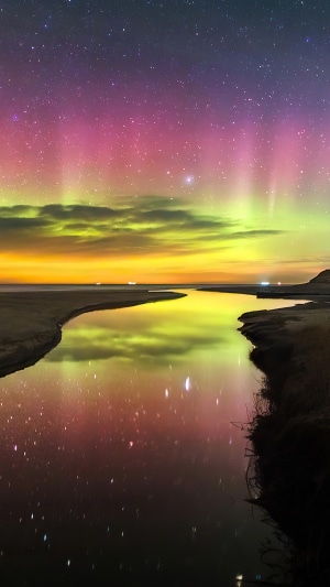 Aurora Borealis over a river and beach