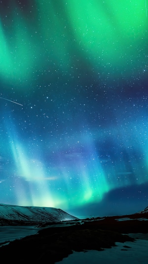 Aurora Borealis over snowy landscape