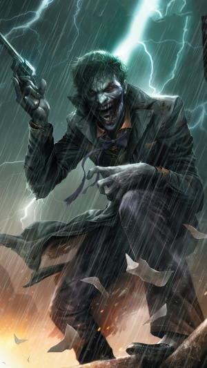The Joker holding a gun in the rain