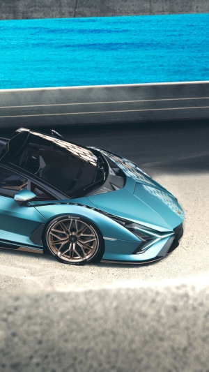 Teal Lamborghini Sian Roadster on a track