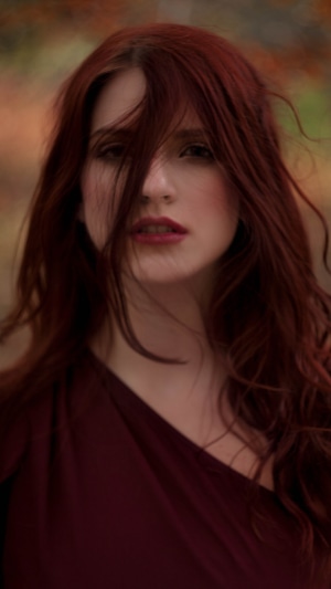 Redhead woman with hair covering face