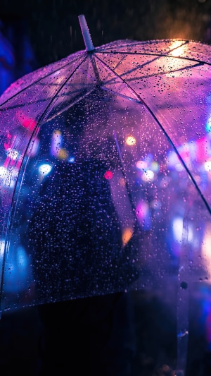 Transparent umbrella in neon city rain 4K