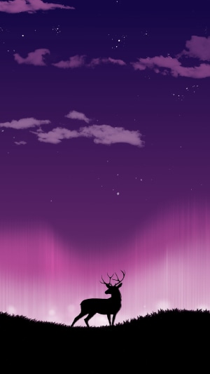Silhouette of a reindeer against a purple and pink sky