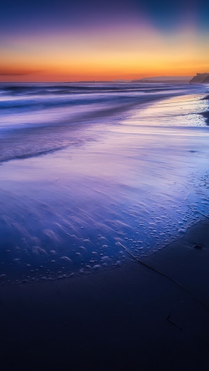 Beach sunset with purple and orange sky