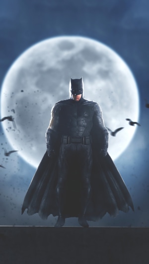 Batman standing in front of a full moon with birds flying