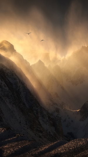 Mountains with sunbeams and birds in 4K