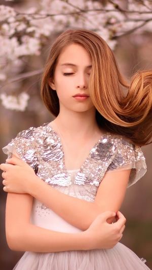 Girl in sequined dress with eyes closed