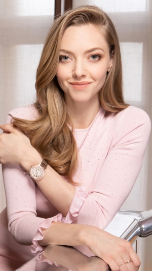 Amanda Seyfried wearing a pink sweater