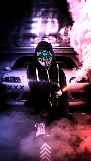 Person in Anonymous Mask with Car and Smoke