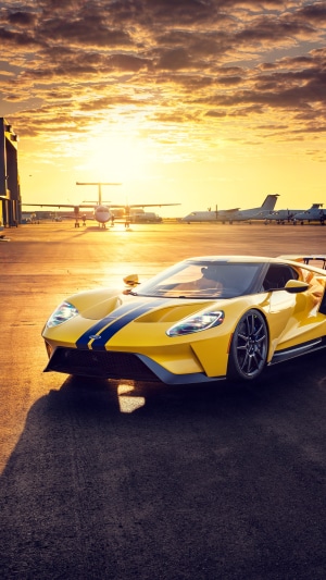 Yellow Ford GT with Blue Stripes at Airport