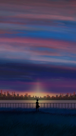 Silhouette of a person watching a sunset over a city skyline