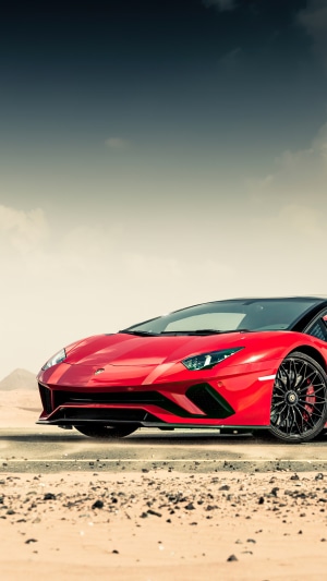 Red Lamborghini Aventador in desert landscape 4K