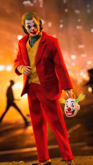 Joker from DC Comics holding a clown mask