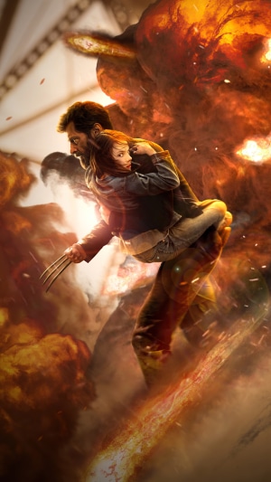 Logan carrying X-23 through an explosion
