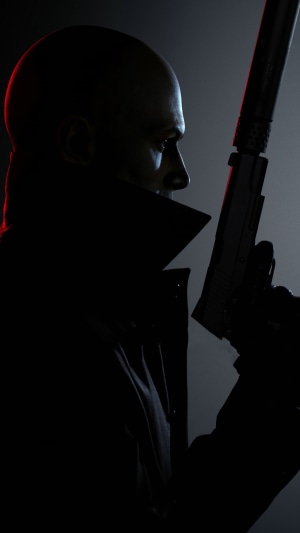 Agent 47 from Hitman 3 holding a silenced pistol