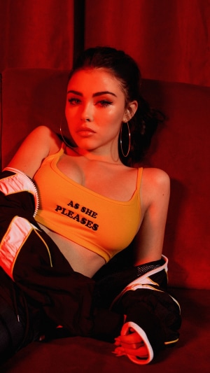 Madison Beer wearing a yellow crop top