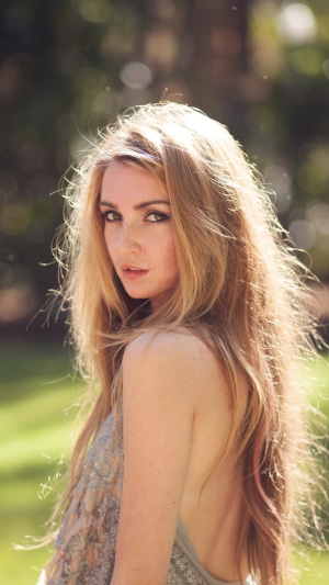 Blonde model with freckles in a dress