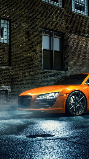 Orange Audi R8 parked on wet street