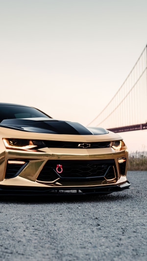 Gold Chevrolet Camaro with Golden Gate Bridge